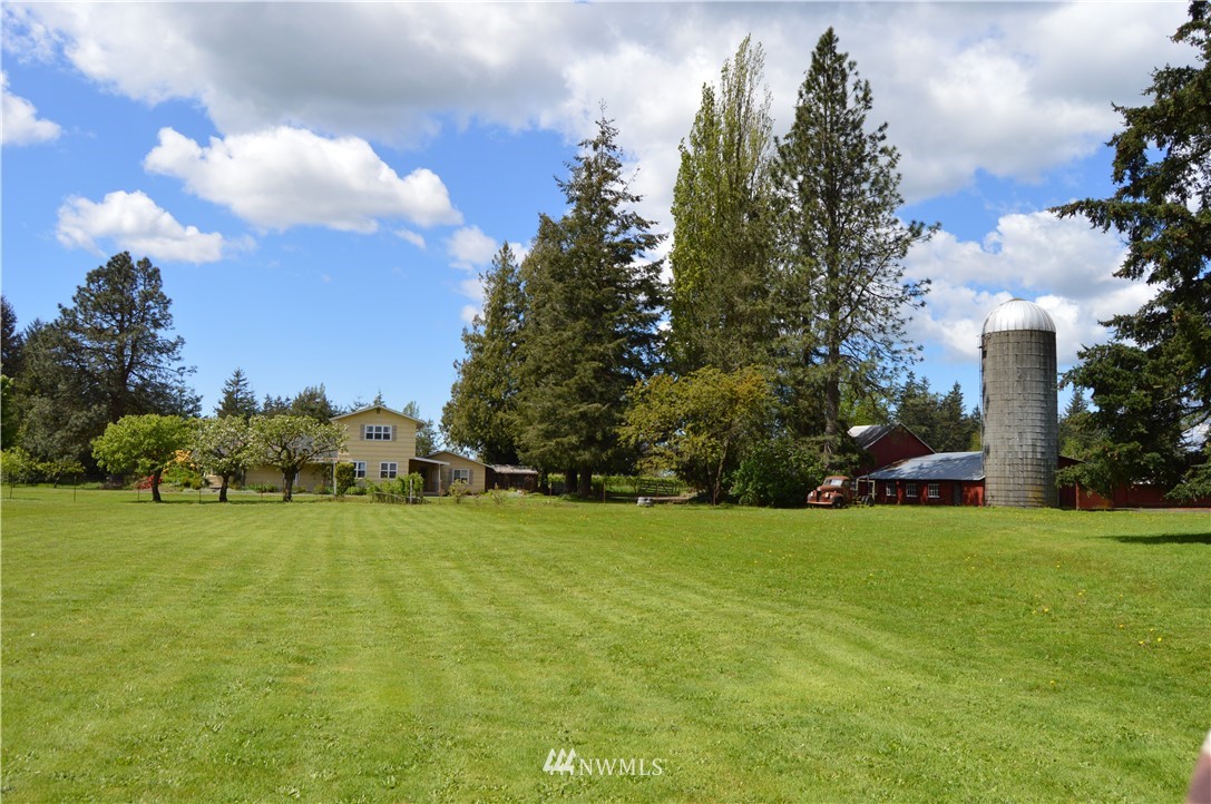 590 West Pole Road Ferndale, WA 98248 - Photo 2 of 40 a view of a grassy field with an trees