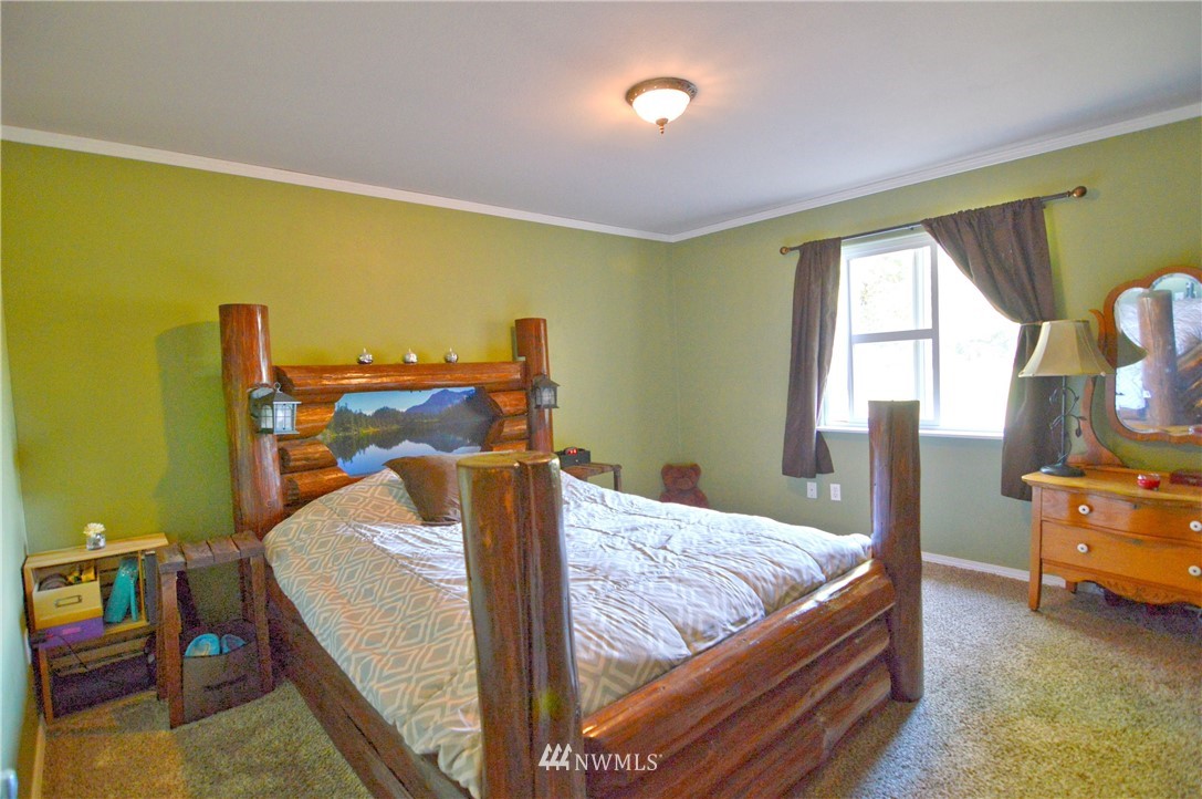 590 West Pole Road Ferndale, WA 98248 - Photo 32 of 40 a bedroom with a bed and wooden floor