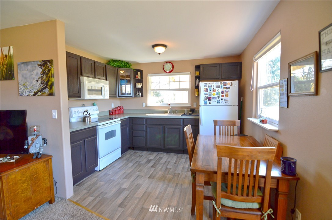 590 West Pole Road Ferndale, WA 98248 - Photo 33 of 40 a kitchen with sink cabinets and wooden floor