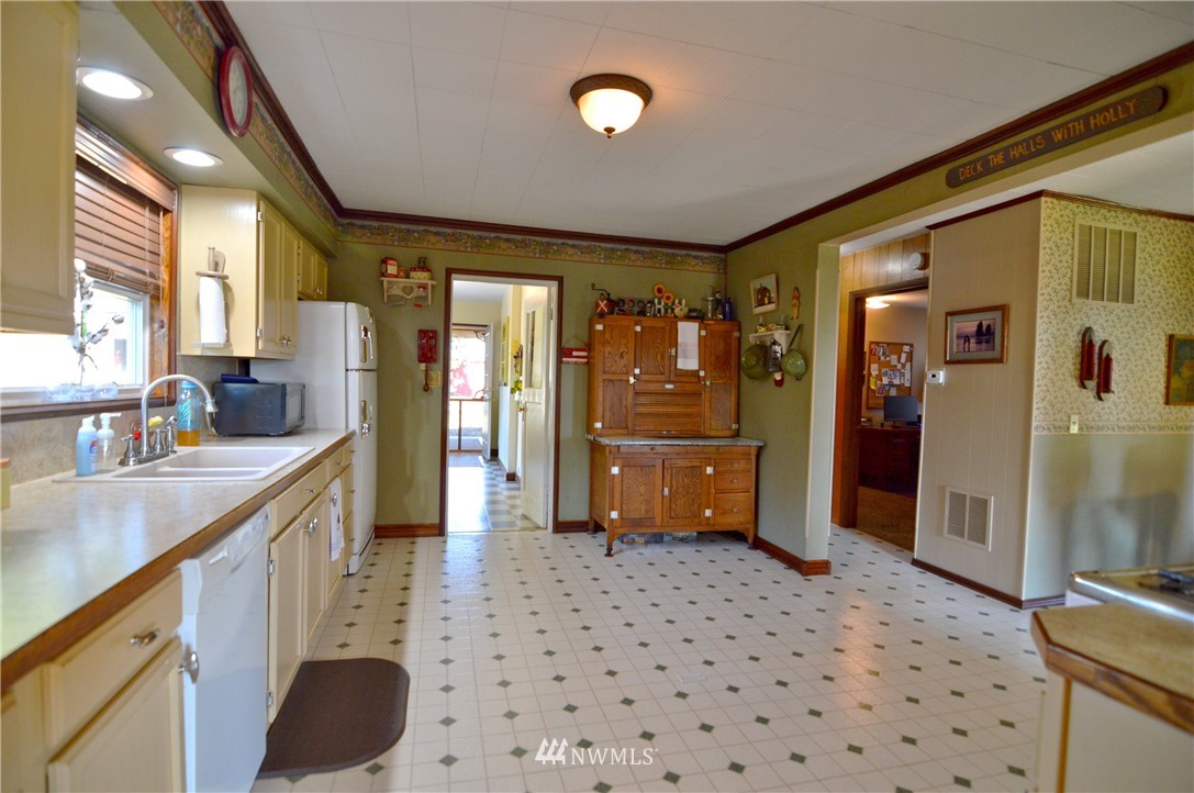 590 West Pole Road Ferndale, WA 98248 - Photo 37 of 40 a kitchen with a sink a refrigerator and cabinets