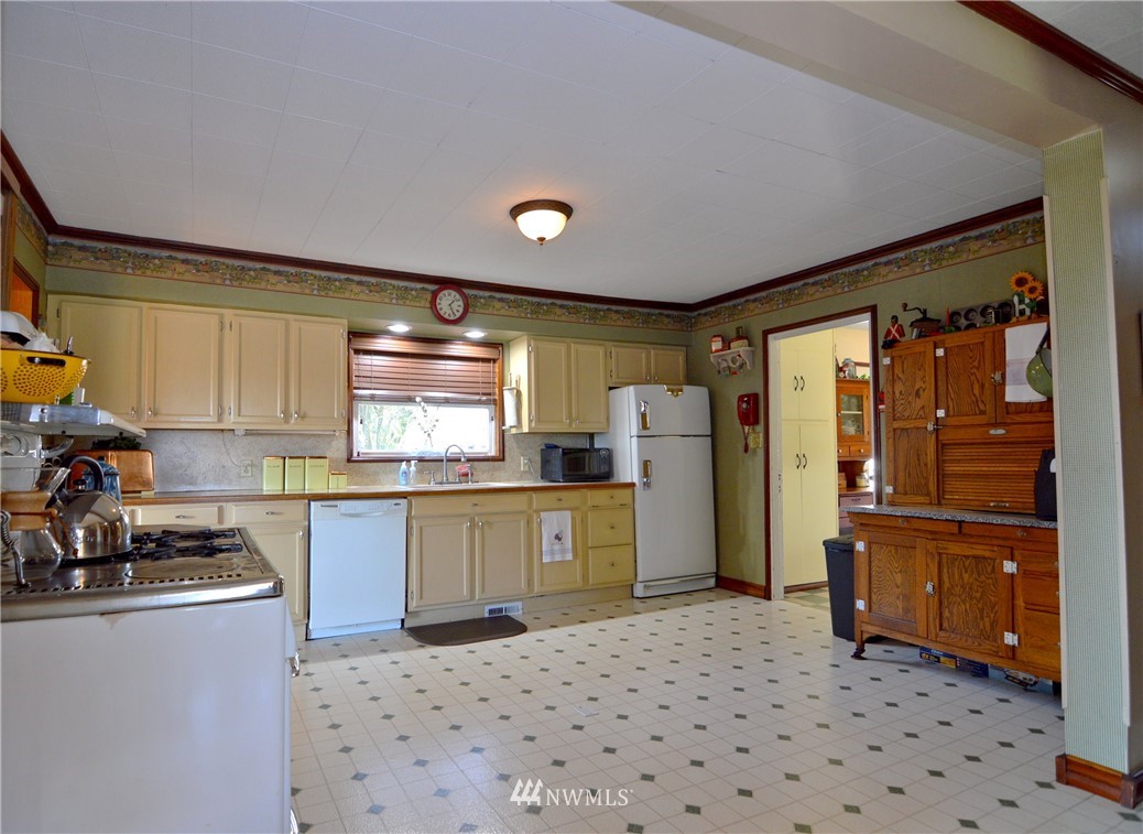 590 West Pole Road Ferndale, WA 98248 - Photo 9 of 40 a kitchen with a refrigerator and a sink