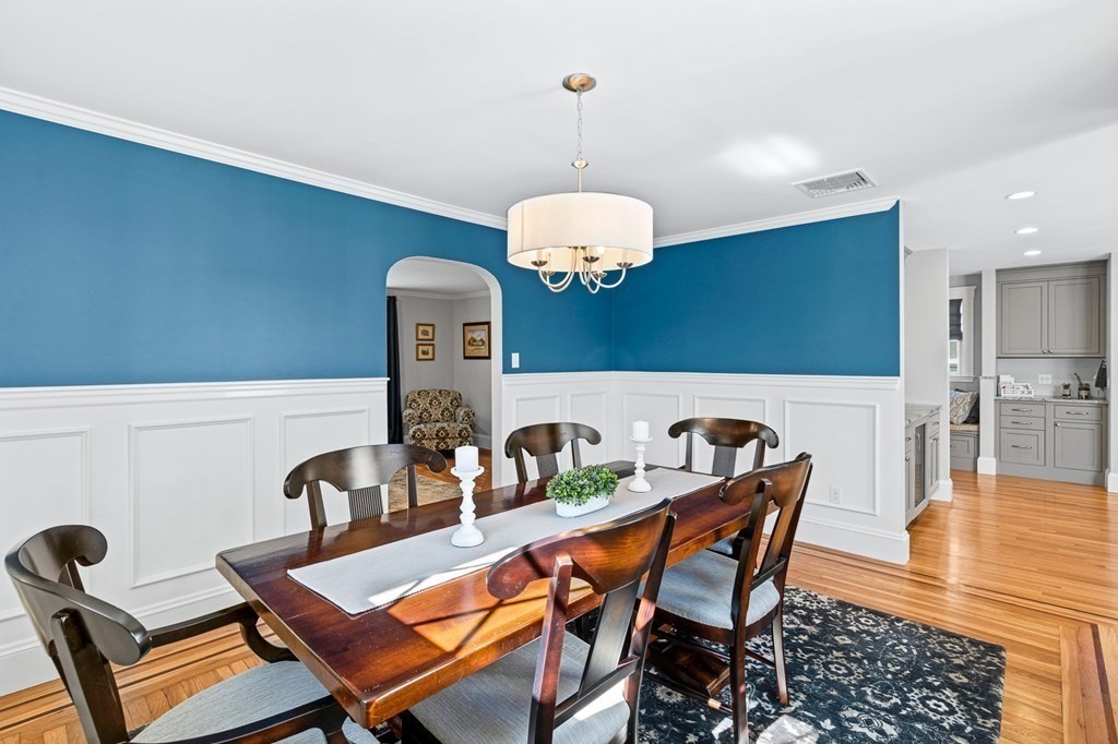 9 Laird Road Medford, MA 02155 - Photo 12 of 41 a dining room with furniture and wooden floor