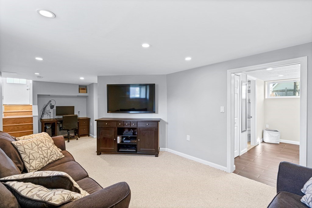 9 Laird Road Medford, MA 02155 - Photo 32 of 41 a living room with furniture and a flat screen tv