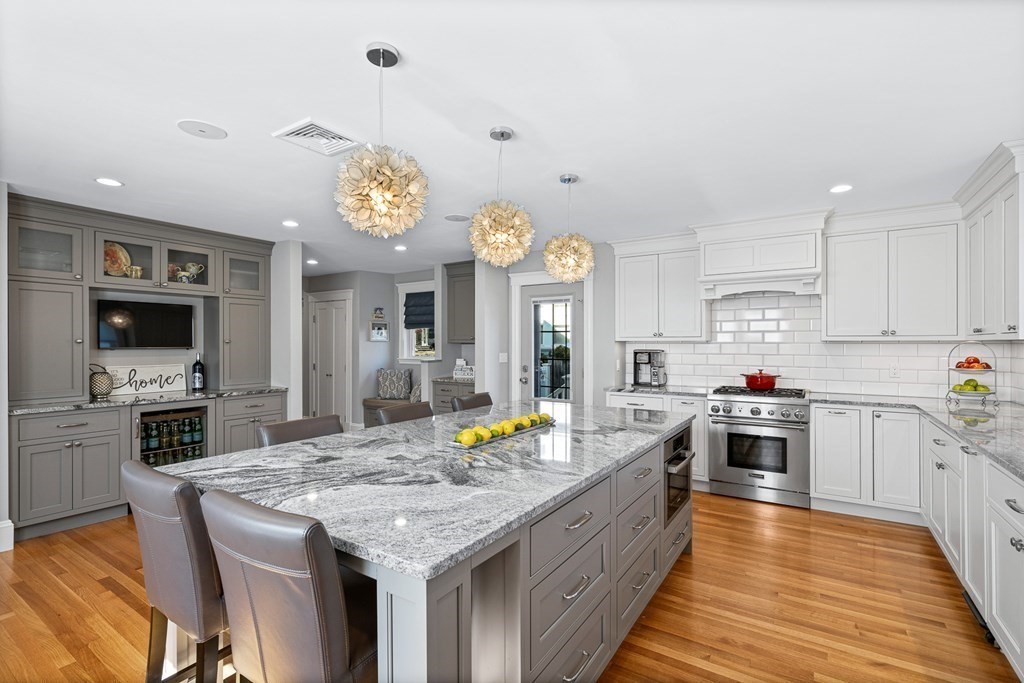 9 Laird Road Medford, MA 02155 - Photo 8 of 41 a large kitchen with stainless steel appliances granite countertop a stove and cabinets