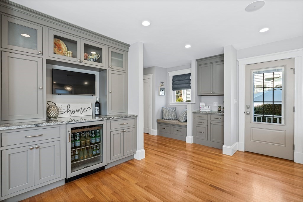 9 Laird Road Medford, MA 02155 - Photo 9 of 41 a large kitchen with cabinets and wooden floor