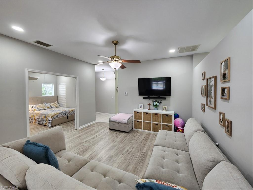 10702 Rio Mar Circle Estero, FL 33928 - Photo 1 of 21 a living room with furniture and a flat screen tv