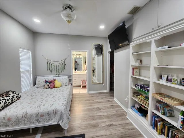 a bedroom with furniture and a book shelf