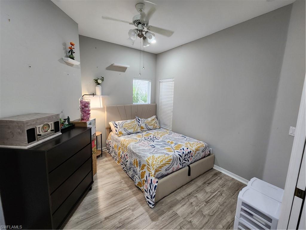 10702 Rio Mar Circle Estero, FL 33928 - Photo 12 of 21 a bedroom with a bed and wooden floor
