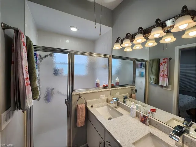 a bathroom with a sink vanity and mirror
