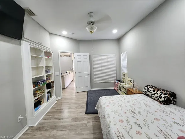 a spacious bedroom with a bed and a large window