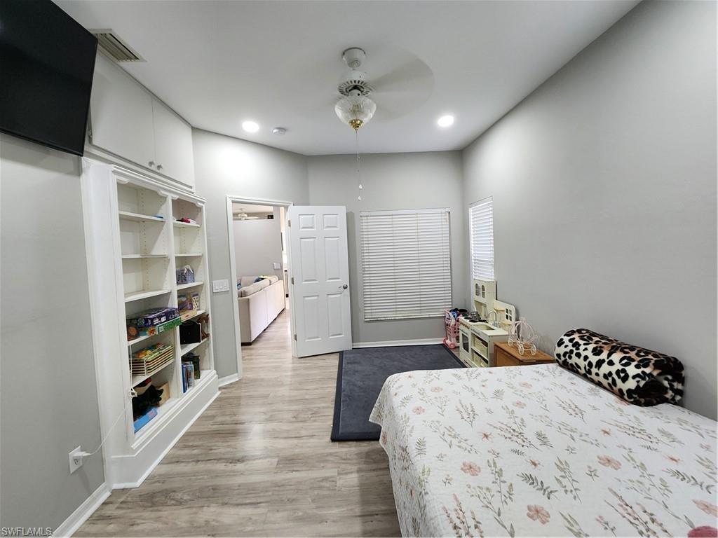 10702 Rio Mar Circle Estero, FL 33928 - Photo 16 of 21 a spacious bedroom with a bed and a large window