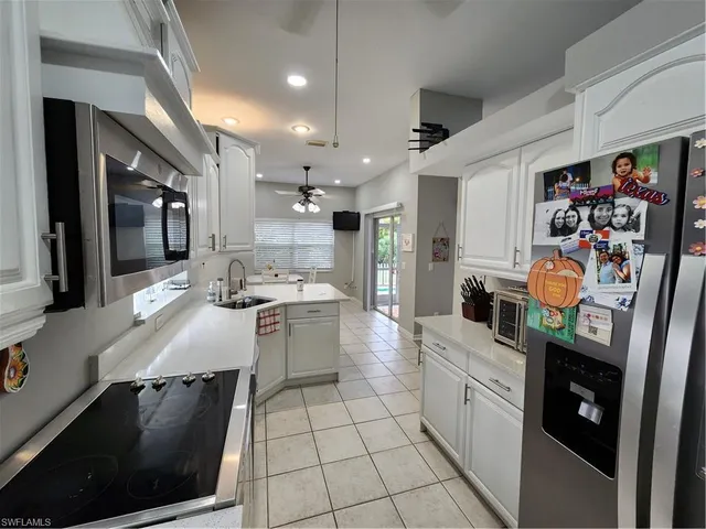 a kitchen with stainless steel appliances granite countertop a sink a stove and a refrigerator