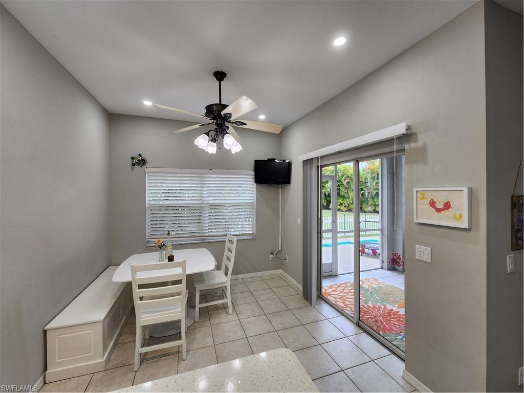 10702 Rio Mar Circle Estero, FL 33928 - Photo 8 of 21 a living room with furniture a chandelier and a window