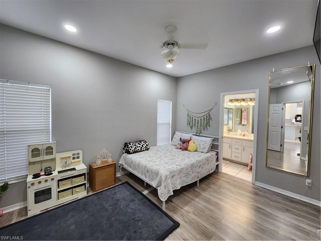 10702 Rio Mar Circle Estero, FL 33928 - Photo 10 of 21 a bedroom with a bed and a chandelier