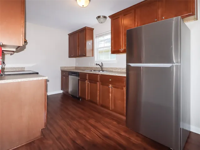 a kitchen with stainless steel appliances a refrigerator and a sink