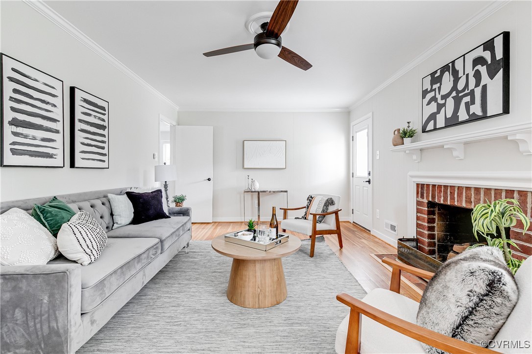 10231 Epsilon Road Richmond, VA 23235 - Photo 12 of 42 a living room with furniture a fireplace and a view of kitchen