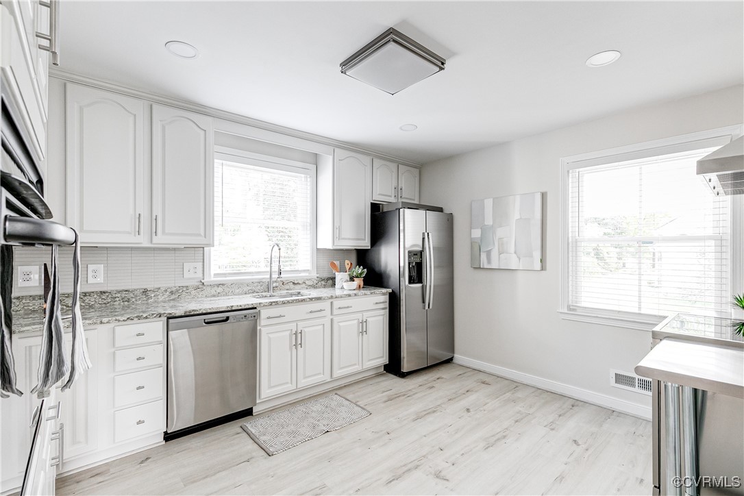 10231 Epsilon Road Richmond, VA 23235 - Photo 16 of 42 a kitchen with stainless steel appliances granite countertop a refrigerator a stove a sink and white cabinets with wooden floor