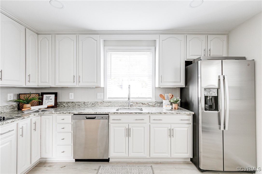 10231 Epsilon Road Richmond, VA 23235 - Photo 17 of 42 a kitchen with white cabinets white stainless steel appliances and sink