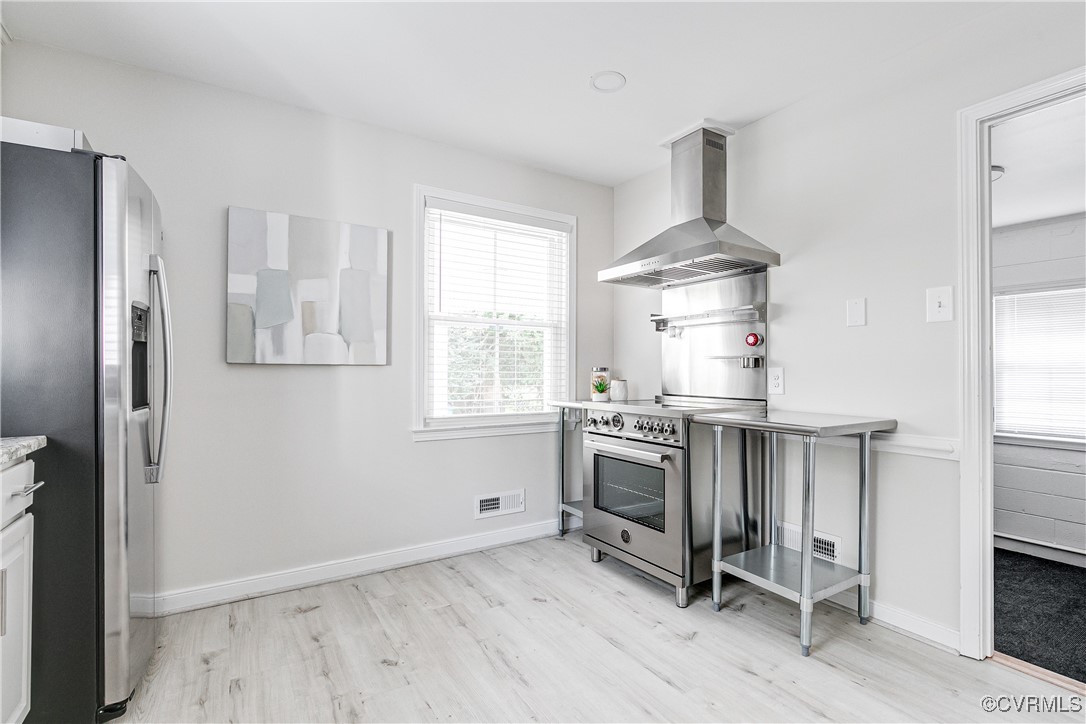 10231 Epsilon Road Richmond, VA 23235 - Photo 18 of 42 a kitchen with stainless steel appliances a stove a refrigerator and cabinets