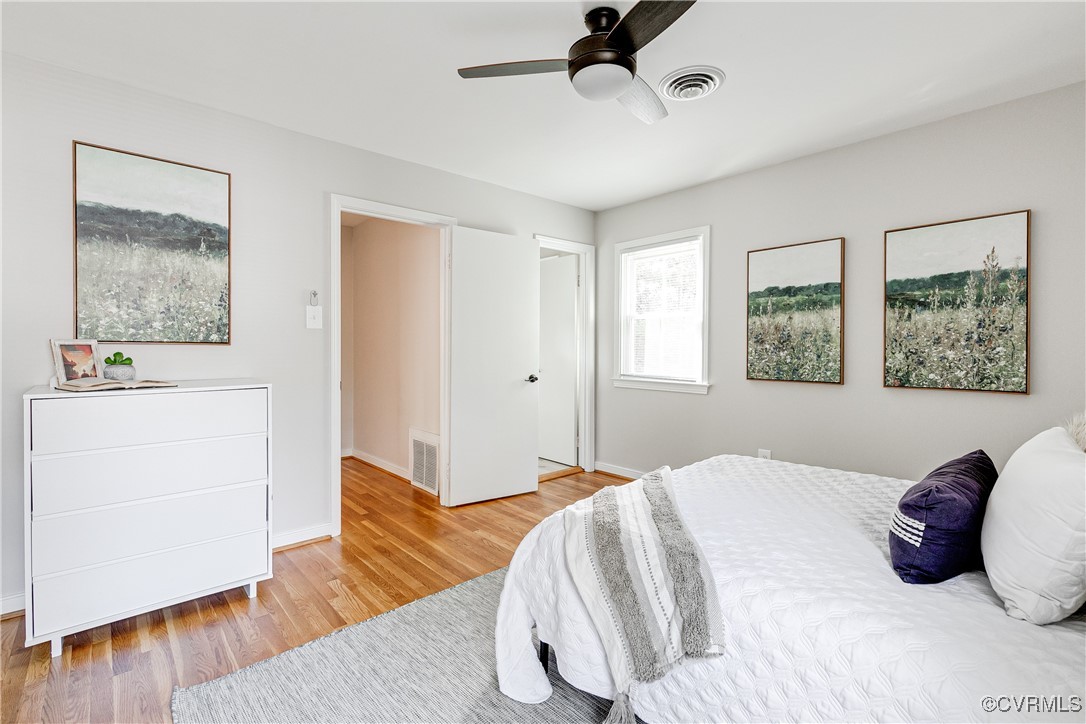 10231 Epsilon Road Richmond, VA 23235 - Photo 24 of 42 a bedroom with a bed and wooden floor