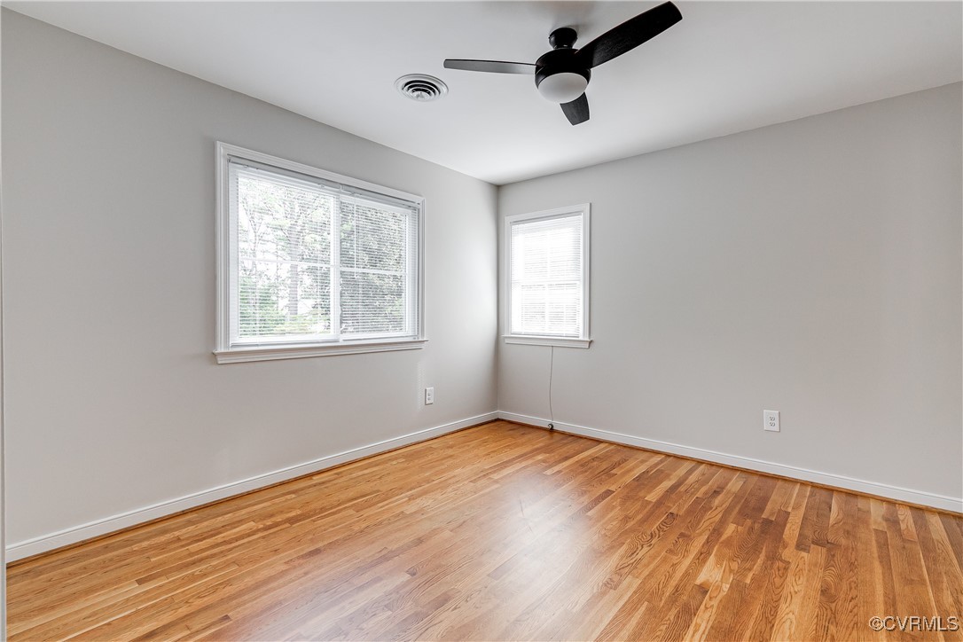 10231 Epsilon Road Richmond, VA 23235 - Photo 31 of 42 a view of an empty room with wooden floor and a window