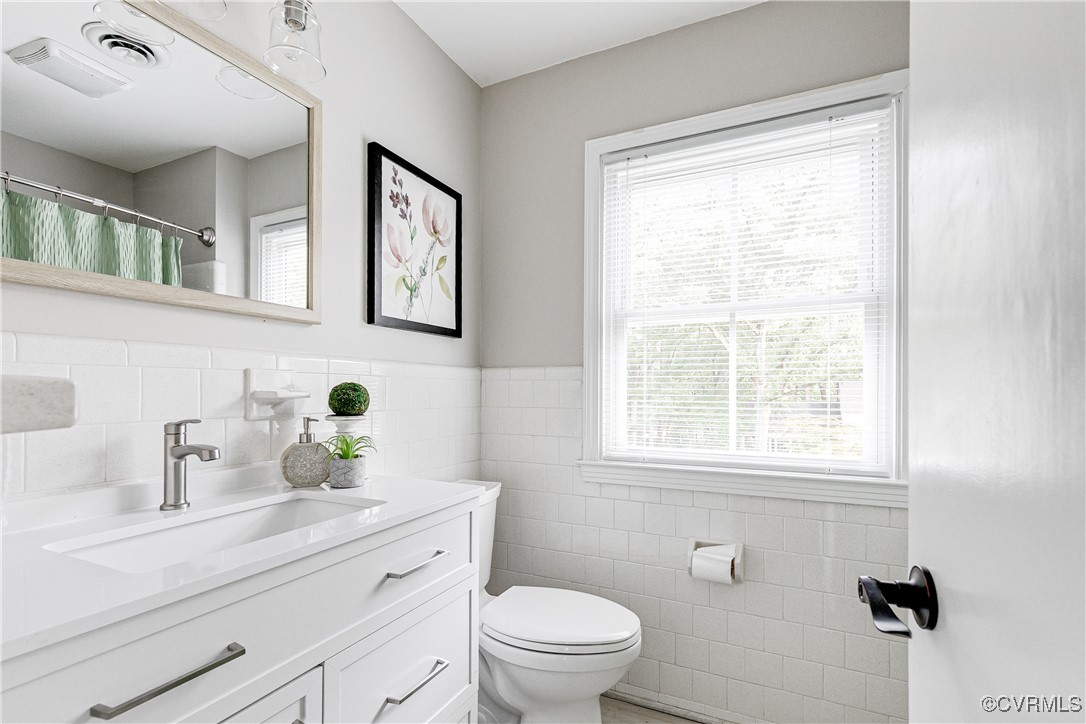 10231 Epsilon Road Richmond, VA 23235 - Photo 32 of 42 a bathroom with a sink a toilet and a window