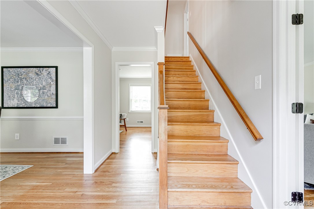 10231 Epsilon Road Richmond, VA 23235 - Photo 8 of 42 a view of a hallway with wooden floor and staircase