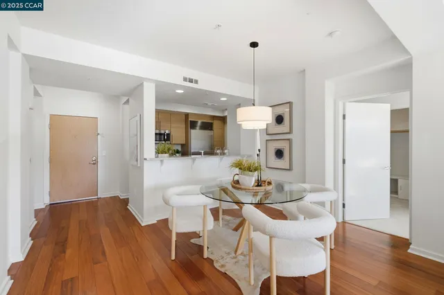 a living room with kitchen island furniture and wooden floor