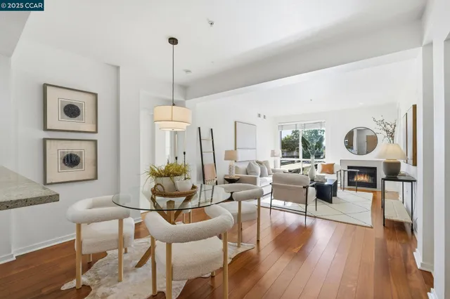 a living room with furniture dining table and a wooden floor