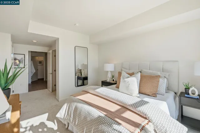 a bedroom with a bed and a potted plant