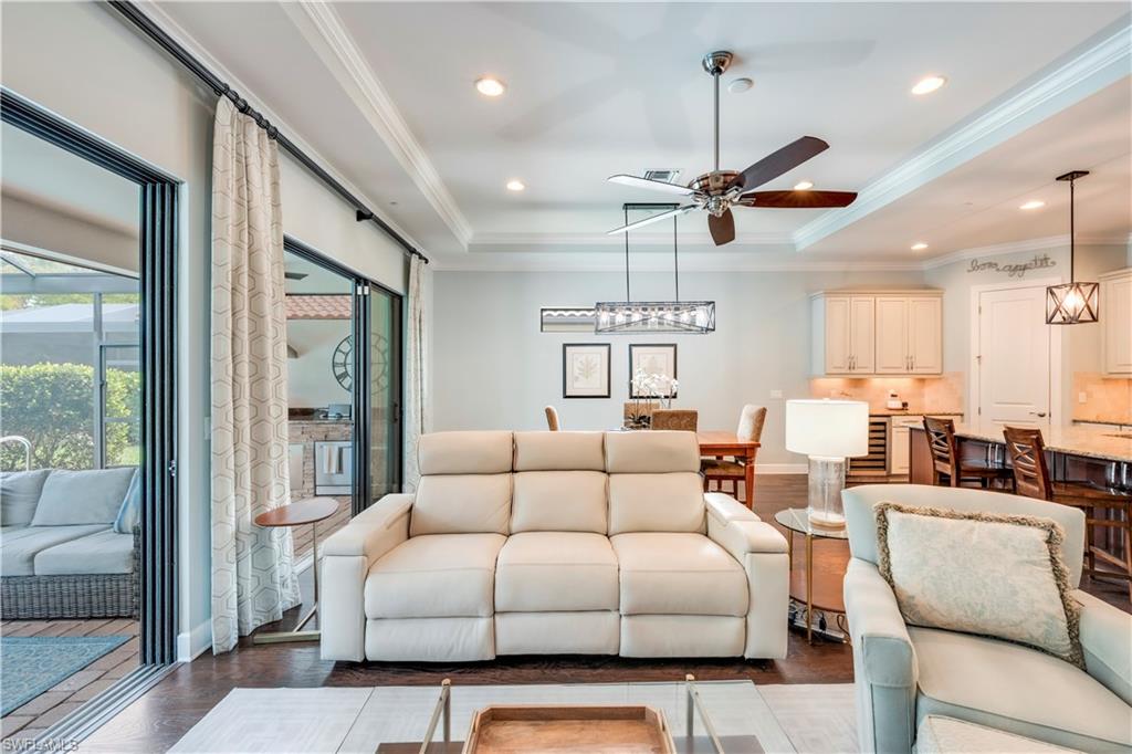 23778 Pebble Pointe Lane Estero, FL 34135 - Photo 12 of 35 a living room with furniture ceiling fan and a large window