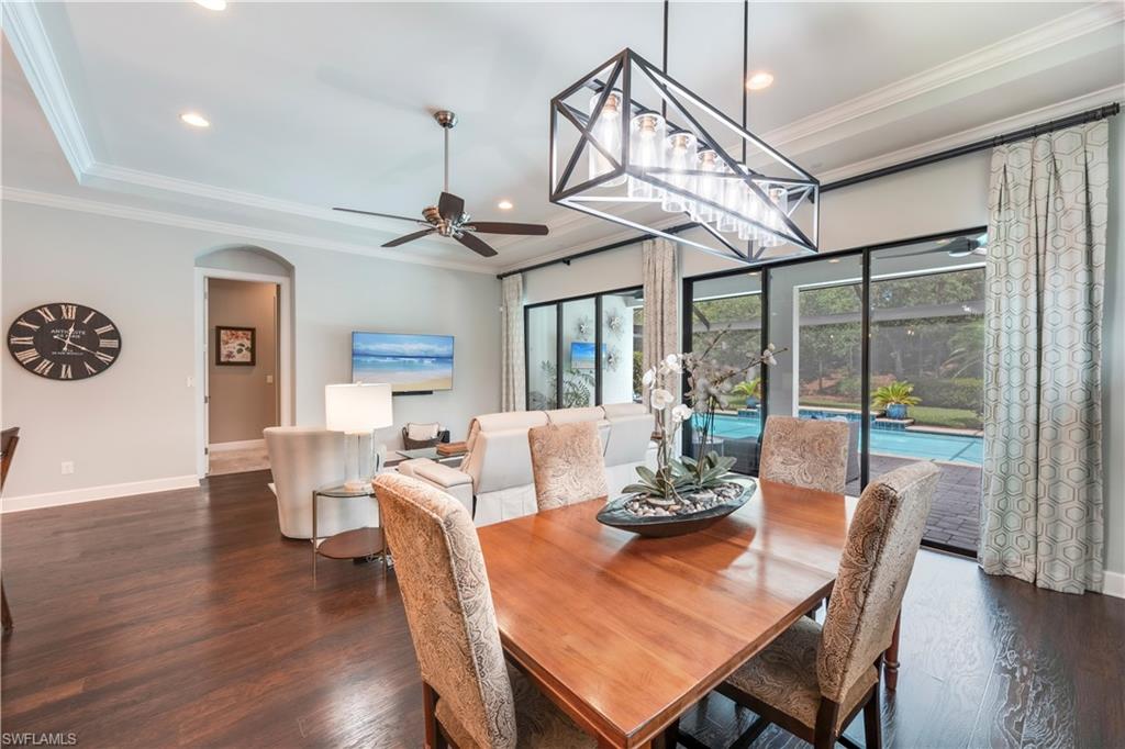23778 Pebble Pointe Lane Estero, FL 34135 - Photo 14 of 35 a view of a dining room with furniture window and wooden floor