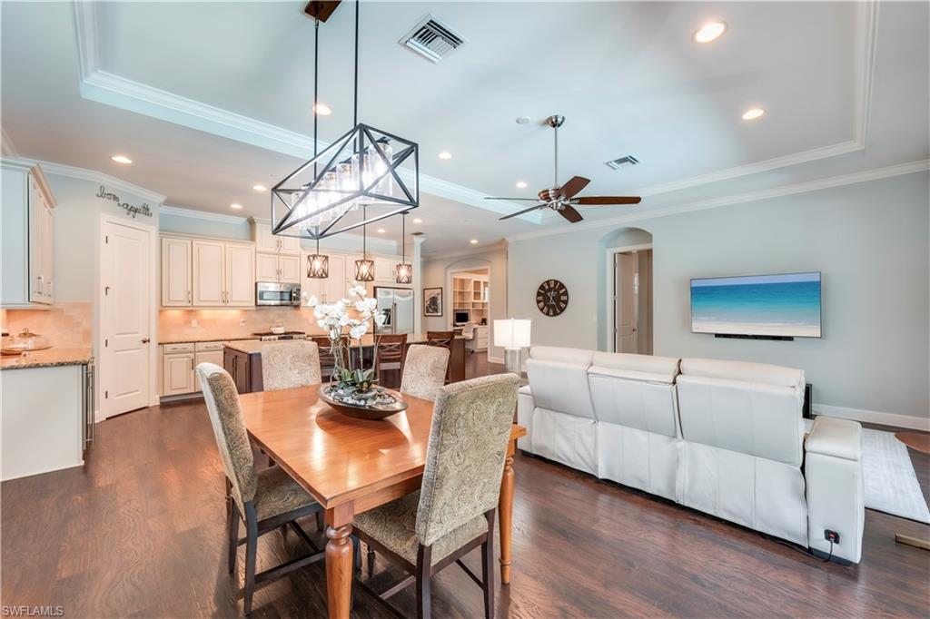 23778 Pebble Pointe Lane Estero, FL 34135 - Photo 15 of 35 a view of a dining room with furniture wooden floor and chandelier