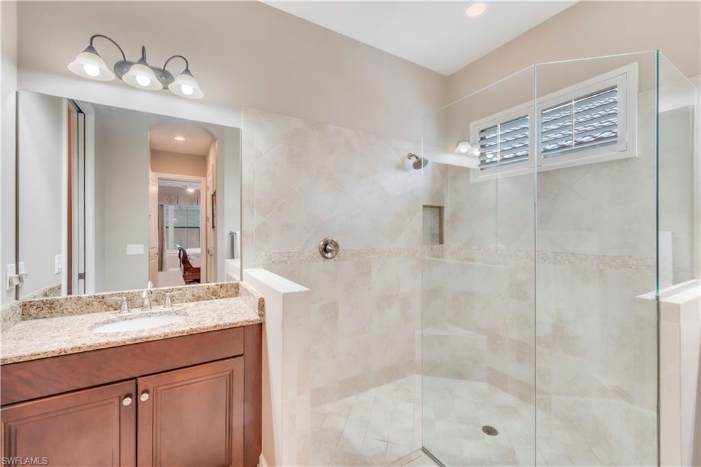 23778 Pebble Pointe Lane Estero, FL 34135 - Photo 25 of 35 a bathroom with a shower sink and mirror