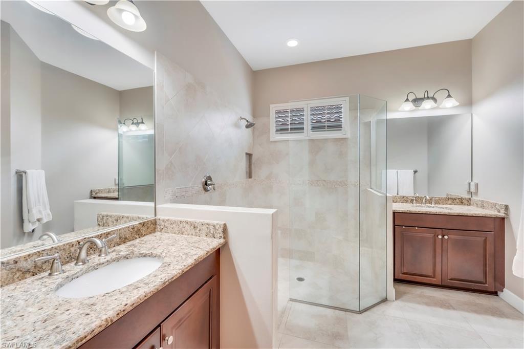 23778 Pebble Pointe Lane Estero, FL 34135 - Photo 26 of 35 a bathroom with a granite countertop double vanity sink and mirror