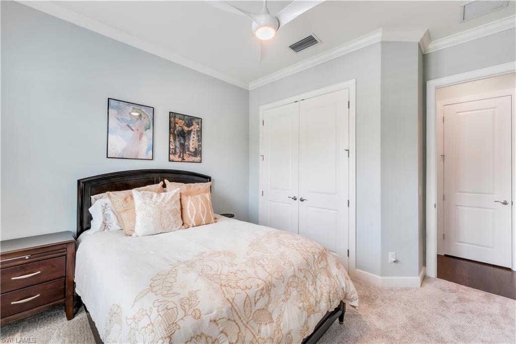 23778 Pebble Pointe Lane Estero, FL 34135 - Photo 28 of 35 a bedroom with a bed and painting on the wall