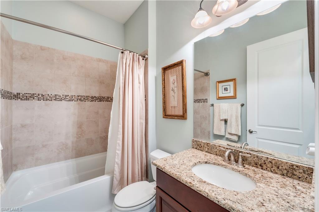 23778 Pebble Pointe Lane Estero, FL 34135 - Photo 29 of 35 a bathroom with a granite countertop sink mirror toilet and bathtub