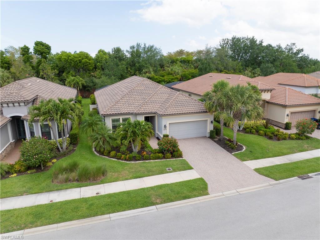 23778 Pebble Pointe Lane Estero, FL 34135 - Photo 31 of 35 a house with green field in front of it