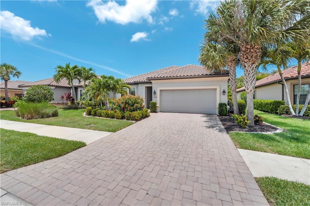 23778 Pebble Pointe Lane Estero, FL 34135 - Photo 32 of 35 a front view of a house with garden