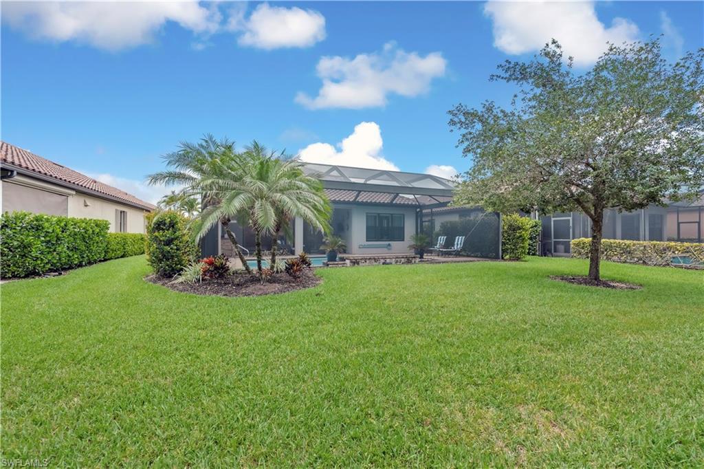 23778 Pebble Pointe Lane Estero, FL 34135 - Photo 33 of 35 a view of a house with backyard porch and garden
