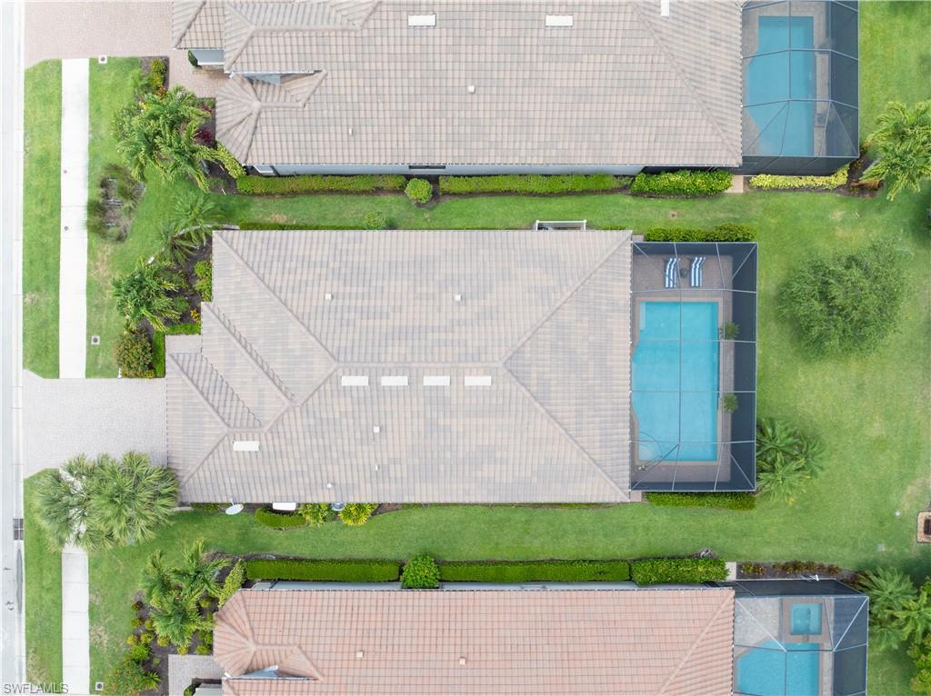 23778 Pebble Pointe Lane Estero, FL 34135 - Photo 34 of 35 a wooden bench sitting in front of a building