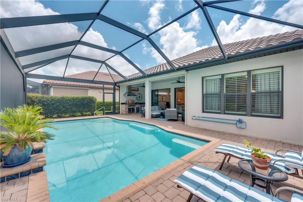 23778 Pebble Pointe Lane Estero, FL 34135 - Photo 4 of 35 a view of a patio with table and chairs and potted plants