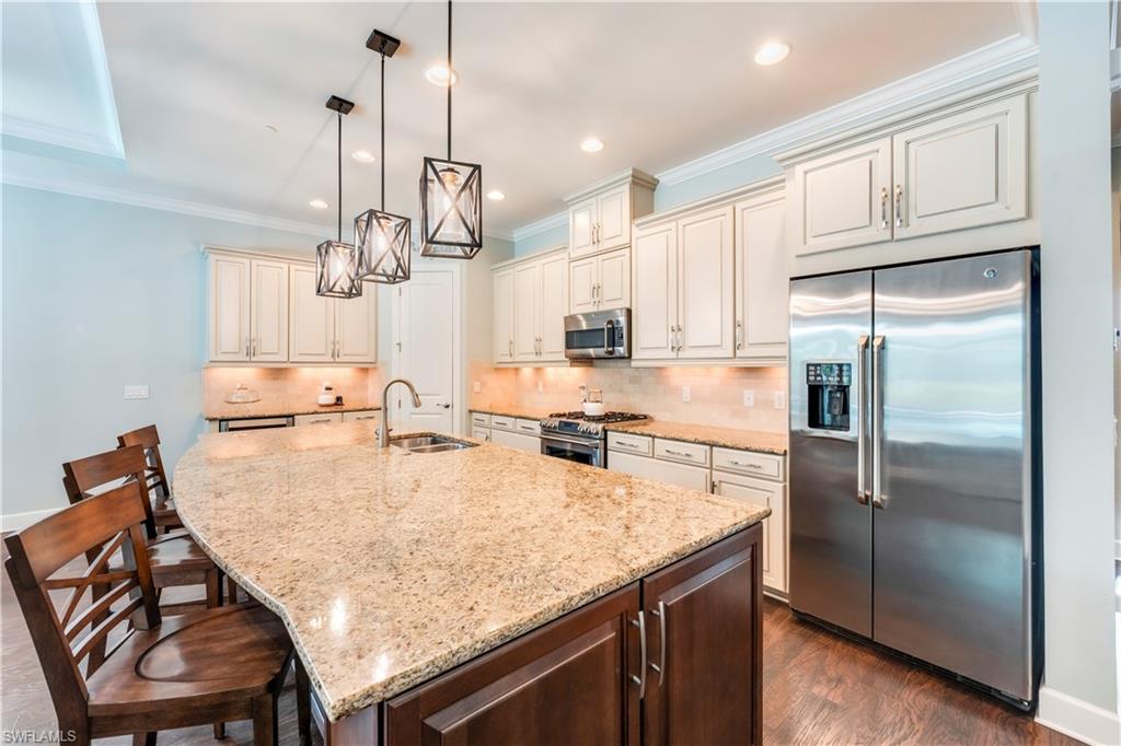 23778 Pebble Pointe Lane Estero, FL 34135 - Photo 8 of 35 a kitchen with kitchen island a counter top space appliances and cabinets