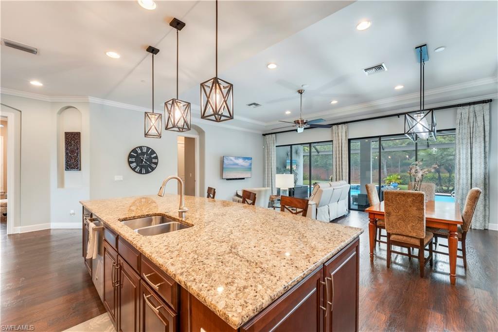 23778 Pebble Pointe Lane Estero, FL 34135 - Photo 9 of 35 a open kitchen with a table and chairs