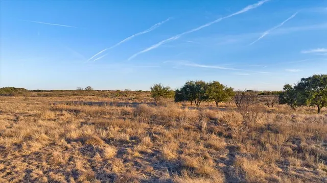 a view of a large building with mountains in the background