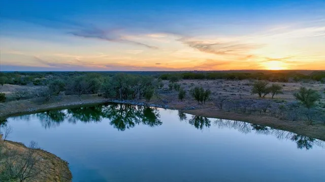 a view of a lake in middle of forest