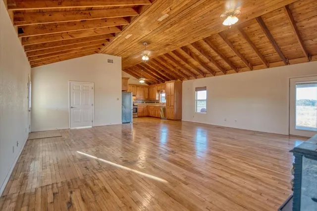 a view of a room with wooden floor