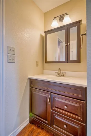 a view of empty room with wooden floor and washer dryer