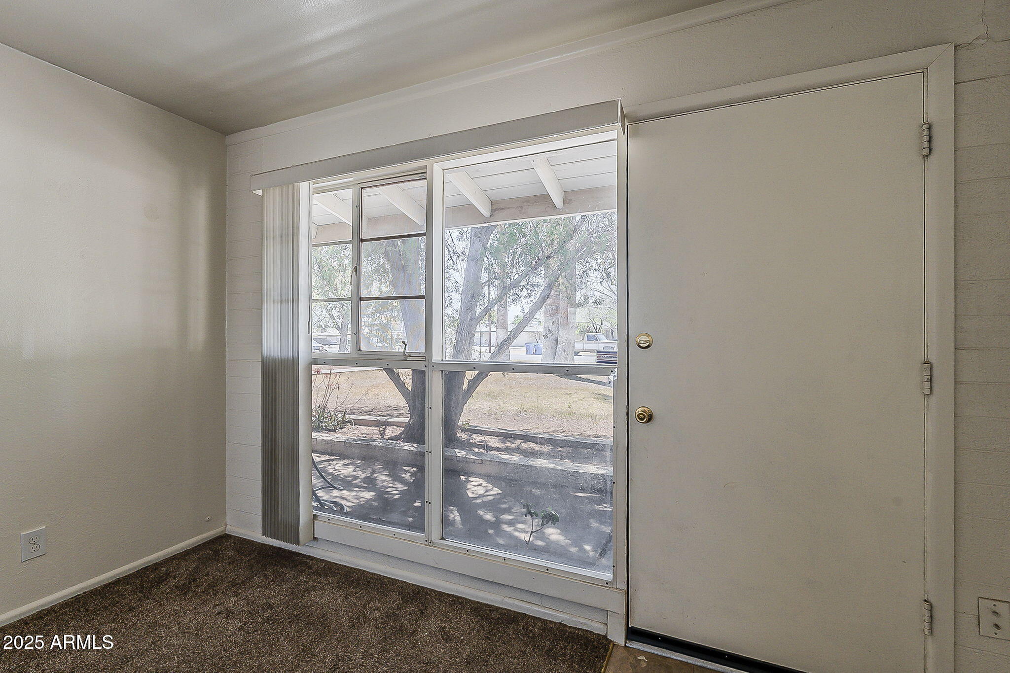 6225 North 10th Place Phoenix, AZ 85014 - Photo 11 of 32 a view of an empty room with wooden floor and a window