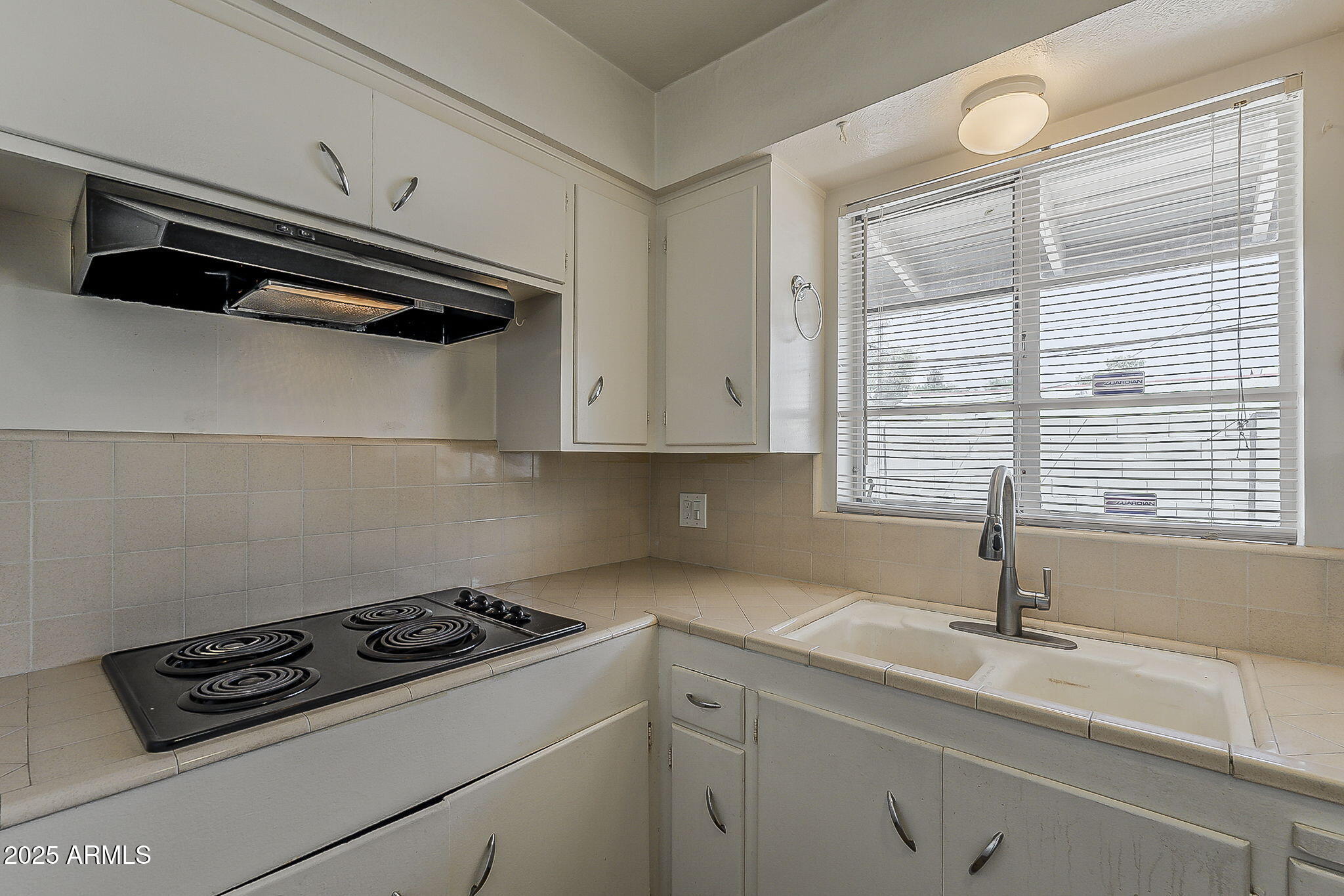 6225 North 10th Place Phoenix, AZ 85014 - Photo 15 of 32 a kitchen with a stove and a sink